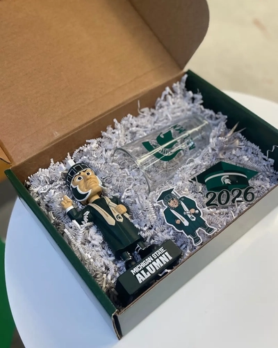 MSU graduation gift box containing Sparty bobblehead, glassware, and 2026 acrylic keepsake.