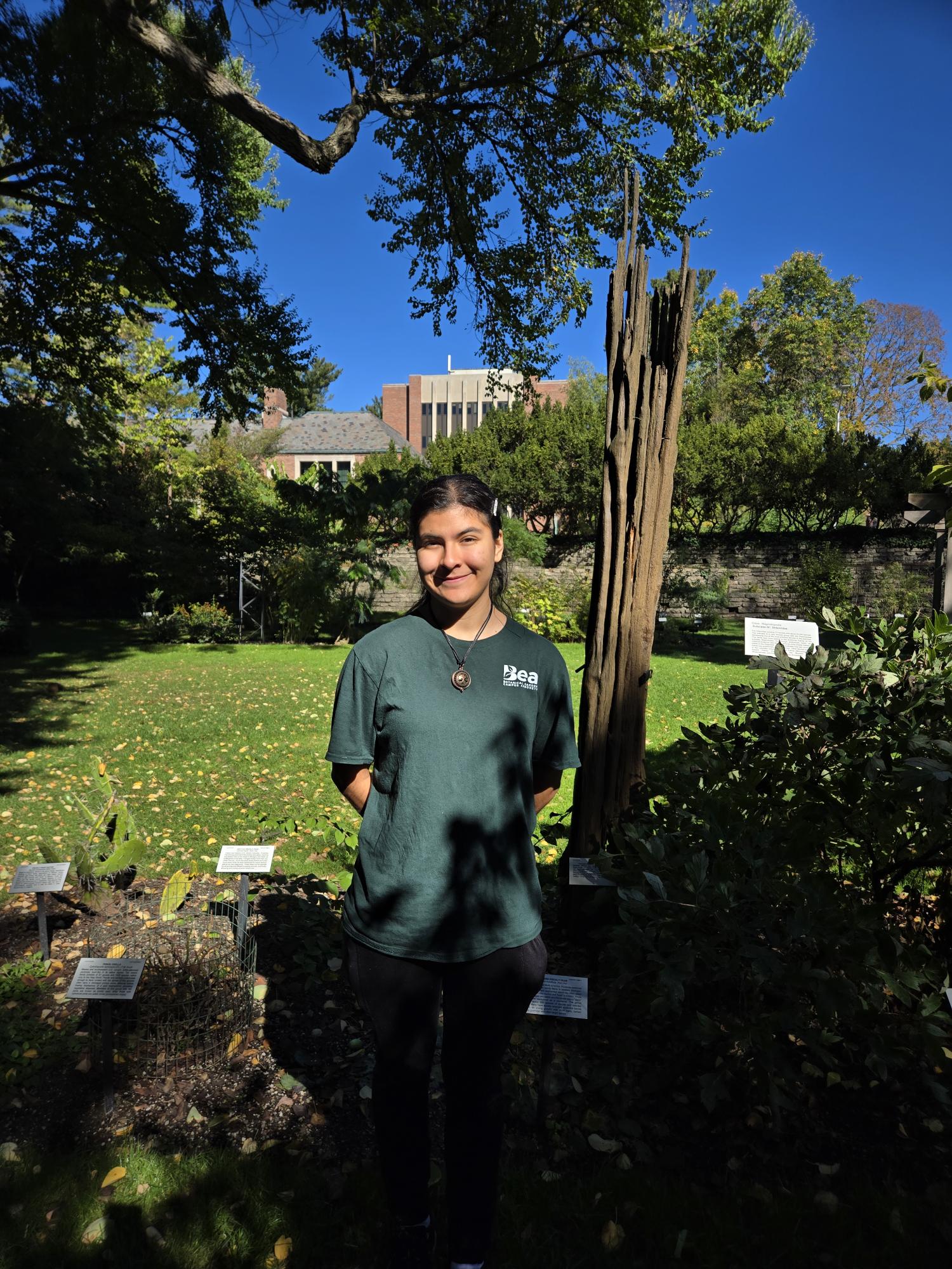 a woman stands in a garden