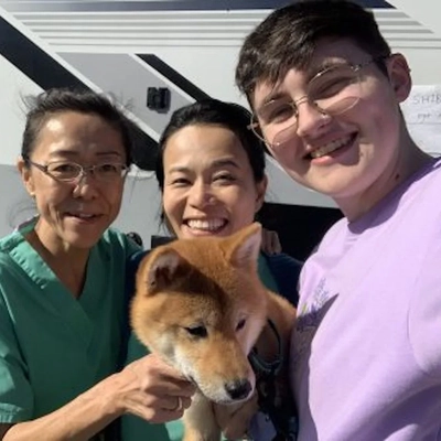 Researchers with a Shiba Inus dog.