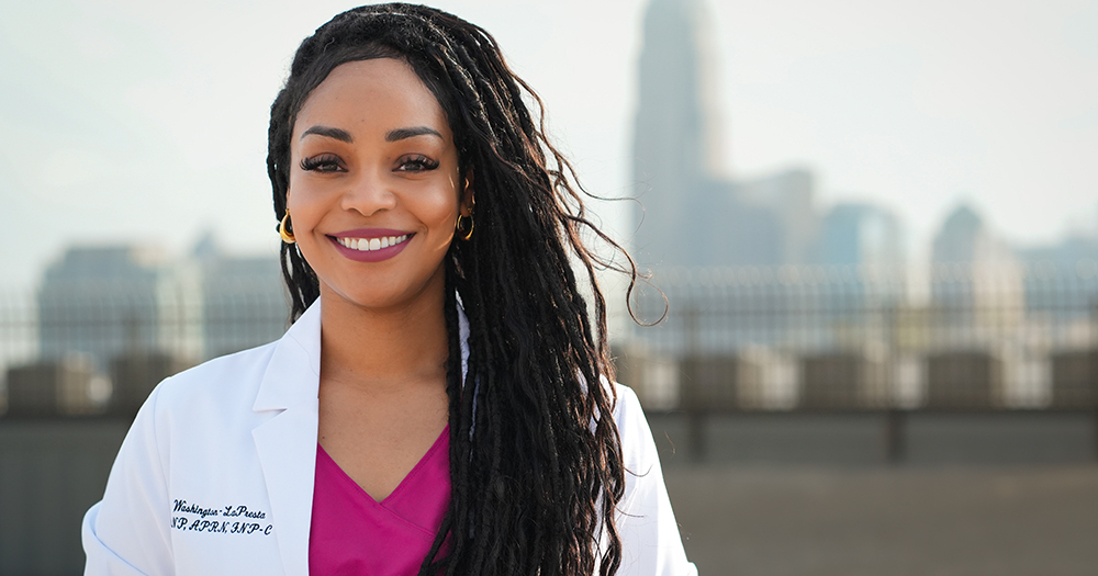 Amber Rose Washington-LaPresta in front of a cityscape