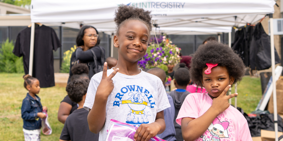 Students from Holmes Brownell Elementary pose during the Flint Community School Garden Pop Ups. Collaborating with the Crim Fitness Foundation and Food Corps, the Flint Registry visited six schools to engage with and provide programming and outreach to around 700 children and families. Photo by Josh Kennedy.