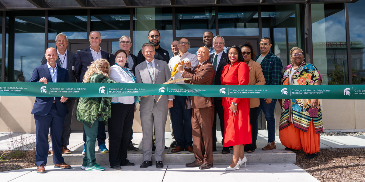Community members prepare to cut the ribbon of the MSU College of Human Medicine Charles Stewart Mott Department of Public Health expansion on Aug. 26, 2025. Photo courtesy of Josh Kennedy, MSU College of Human Medicine.