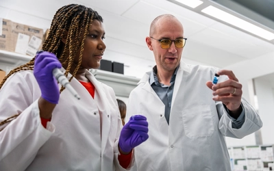 Aaryn Edwards, MSU graduate student, and Geoffroy Laumet, MSU Associate Professor of Physiology, work on a sample in Laumet’s lab.