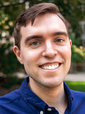 close up of a man smiling outdoors