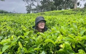 Colin Reese smiles while standing among lush green plants during his study abroad experience in South Asia.