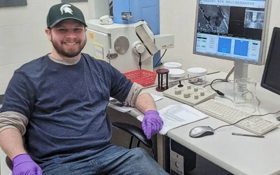 Ethan Fletcher, a Ph.D. by a computer testing materials