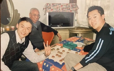 Three people pose for a photo in 2006 in Tianjin, China