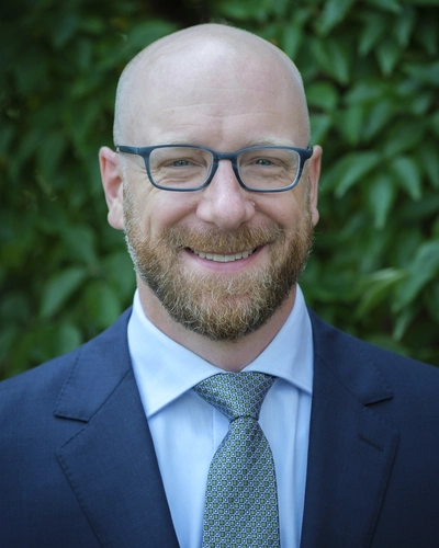 Soren Anderson, associate professor in MSU's Department of Economics at the College of Social Science, smiles in his portrait.