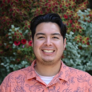 Portrait of a smiling MGI Ph.D. graduate Jasper Gomez.