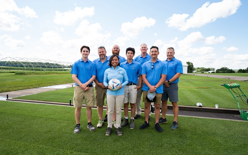MSU turfgrass research team standing with turfgrass plots from left to right: Elijah Delaney, Ryan Bearss, Evan Rogers, Zach Flink, Trey Rogers, Jake Kilby, Jesse Sholl with Jackie Guevara in front (center)
