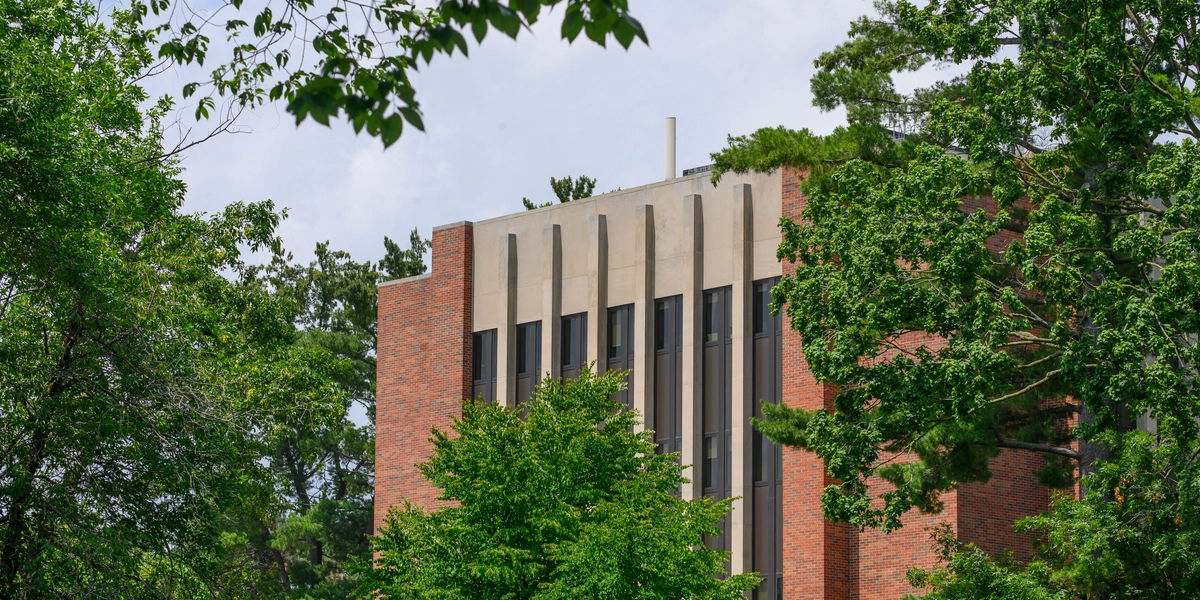 MSU Music Practice Building framed by summer leaves