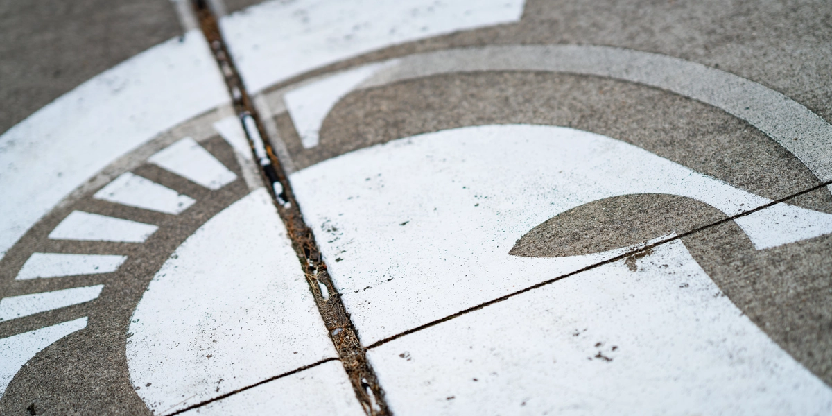 A Spartan Helmet painted at center court of a basketball court near Mary Mayo Hall.
