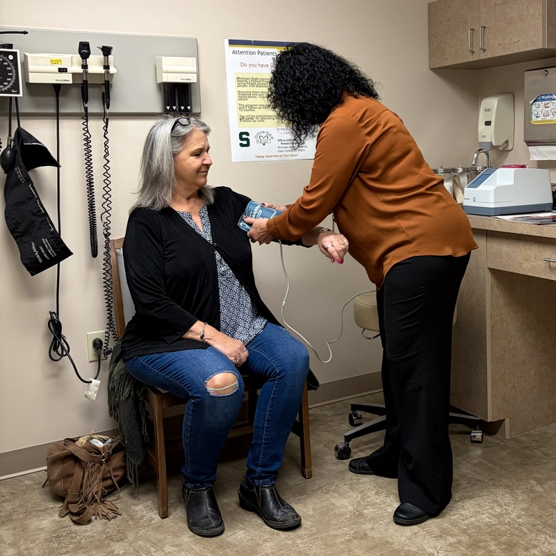A clinician positions a patient on an imaging scanner for a health study.