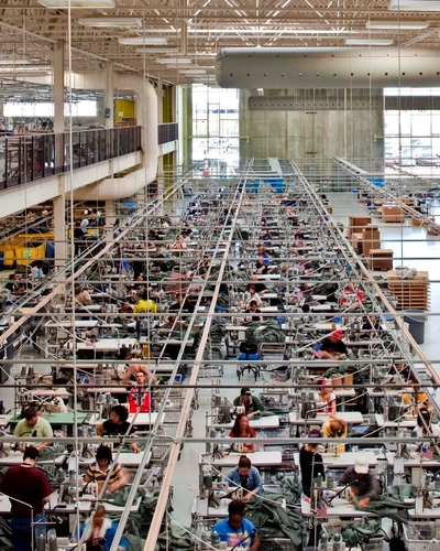 Wide shot of people working on a production floor