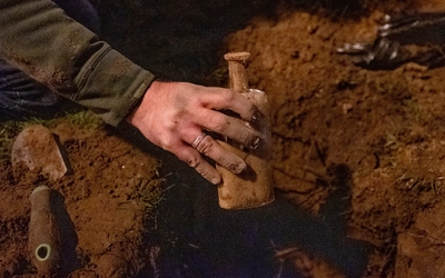 An excavated bottle of seeds being removed as part of the William J. Beal Seed Experiment.