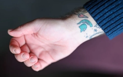 Wright's Spartan helmet tattoo on his wrist