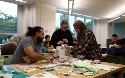 Participants collaborate during a sewing workshop