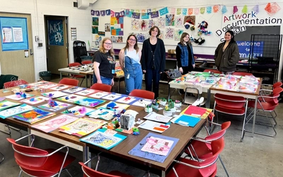 Art Education majors (from left to right) Breanna Chaput, Elizabeth Hofer, Kelsey Smith, Libby Wortman, and Gina Budman gathered with artwork from the SmART Student Exhibition.