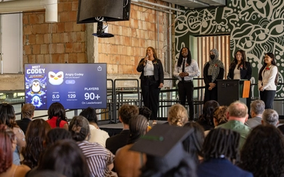 Several learners from the Apple Developer Academy present their Meet Codey App at the Apple Developer Academy graduation ceremony