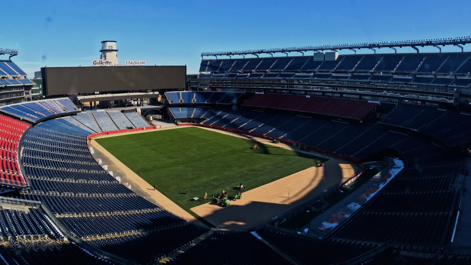 Workers installing new turf at Gillette Stadium under a clear blue sky. MSU science behind the World Cup Thumbnail