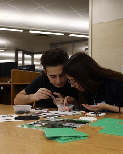 Students collaborate on a Perler bead project