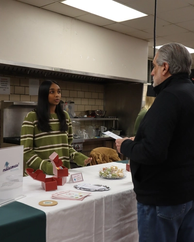 Pulavarthi sharing macaronza! with alum Joe Germanotta.
