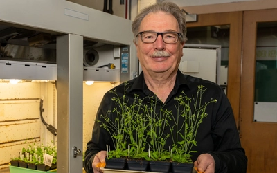Christoph Benning holding a plant