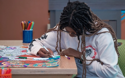 A student coloring in the Makerspace