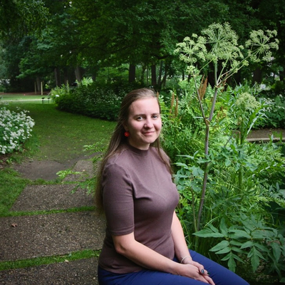 A woman sitting in a garden