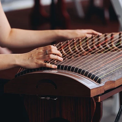 A traditional 21-string guzheng being played
