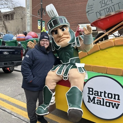 Elena Simovski with sparty on a parade float