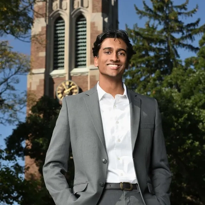 Aswath Karai standing in front of Beaumont Tower