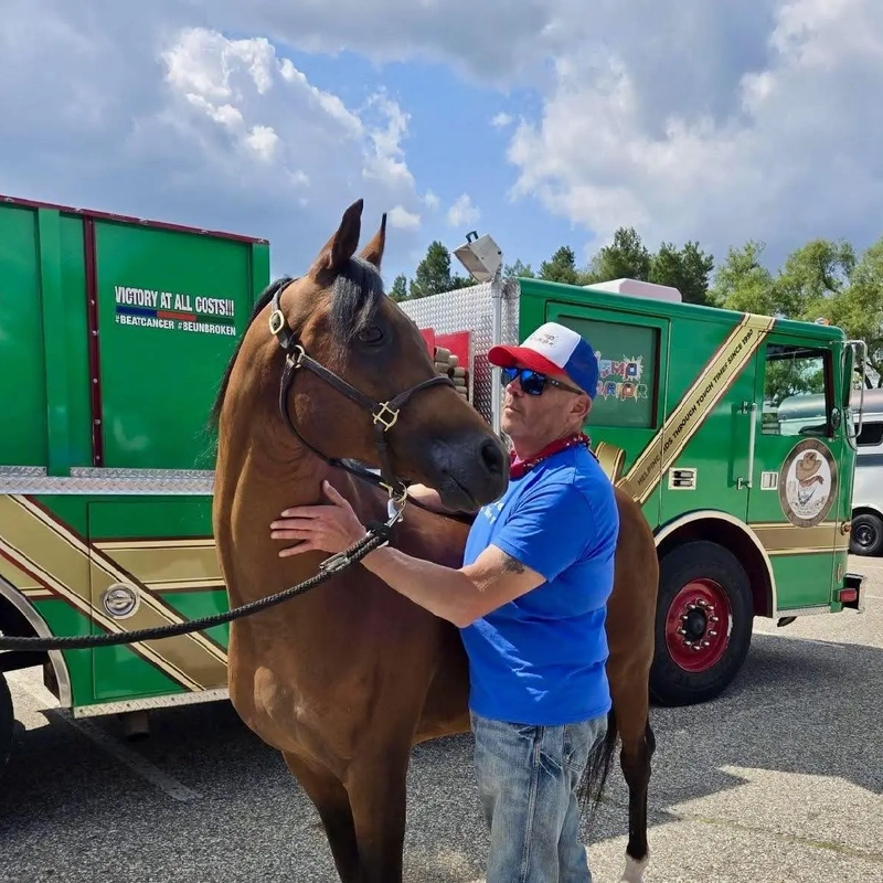 Gayelord Mankowski with his horse in front of a green truck