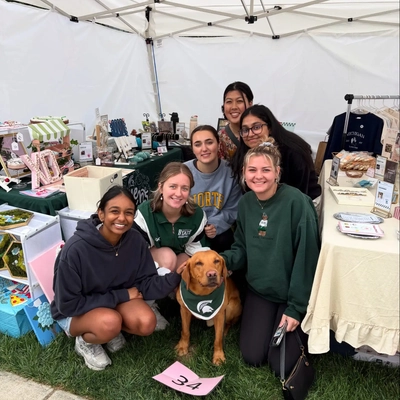 Members of Student-Made Michigan at a pop up event with Zeke the wonder dog