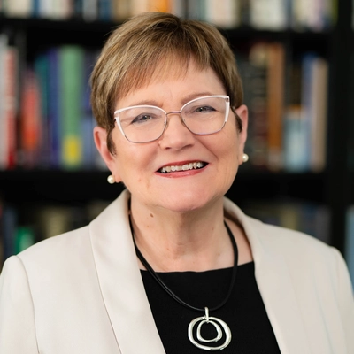 Ann Austin poses wearing a sportcoat and a necklace