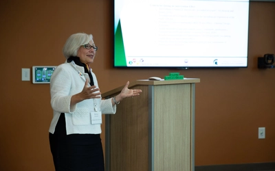 Barbara Schneider speaks to room of students.