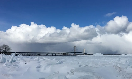 A view of the Mackinac Bridge from a frozen shore