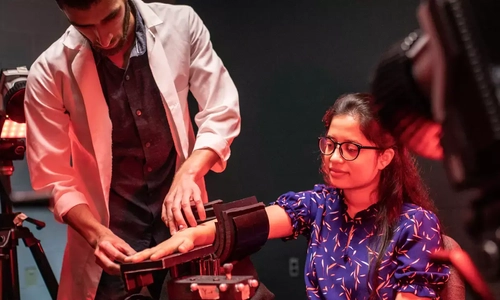 Researchers conducting biomechanics testing with motion sensors and wearable technology