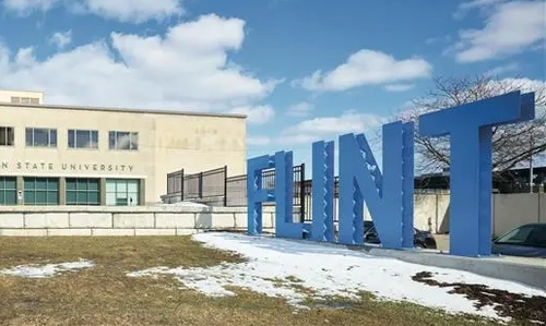 A sign that says Flint in capital letters in front of a building.