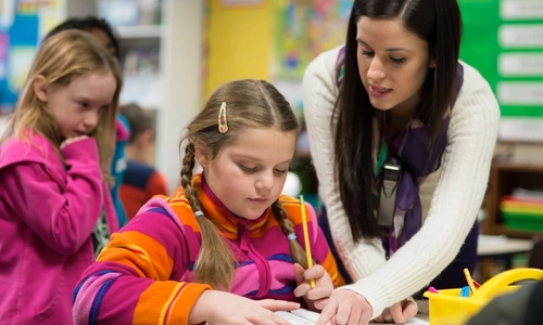 Teacher helping students